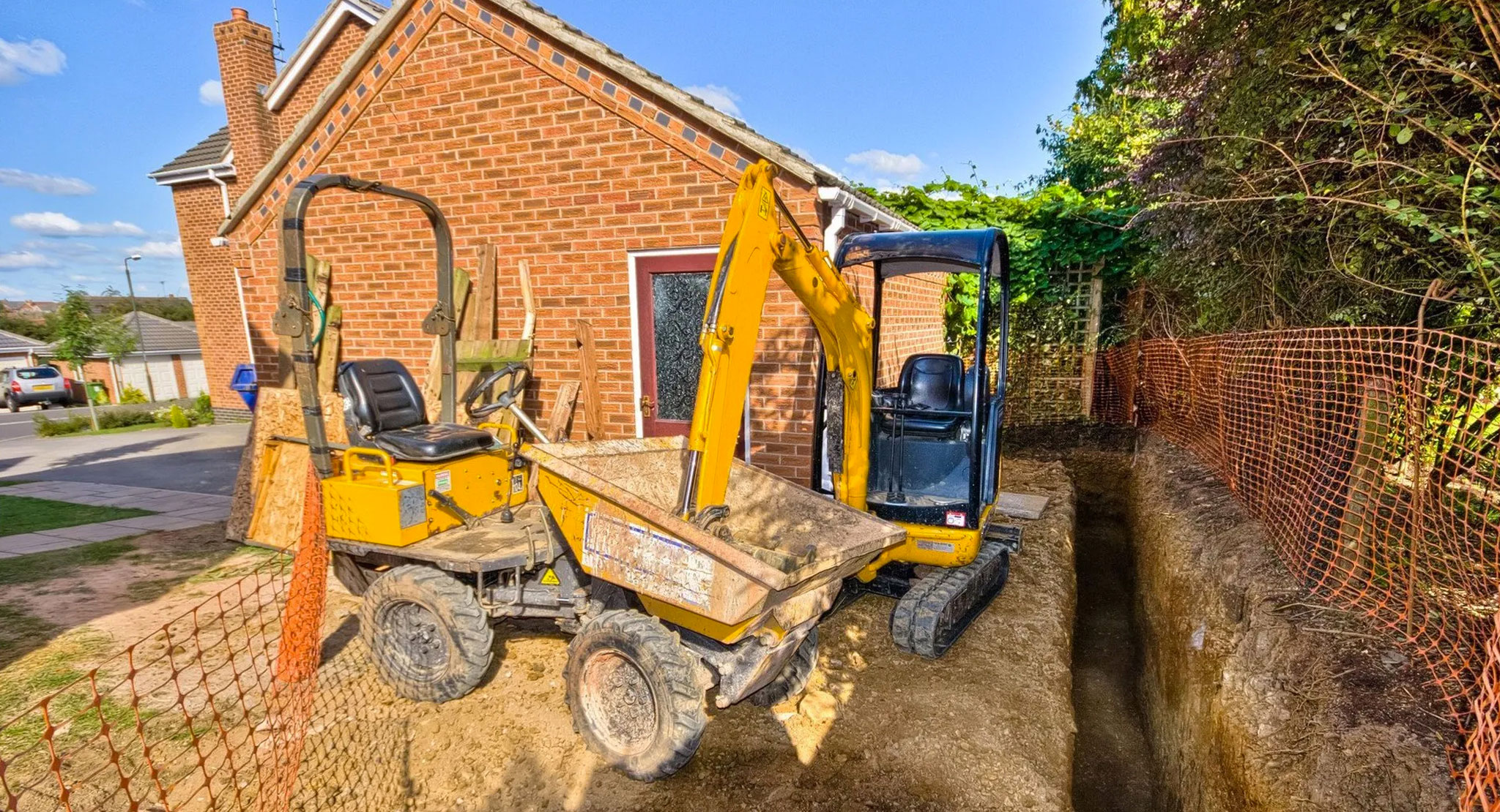 Dump truck and mini digger in garden