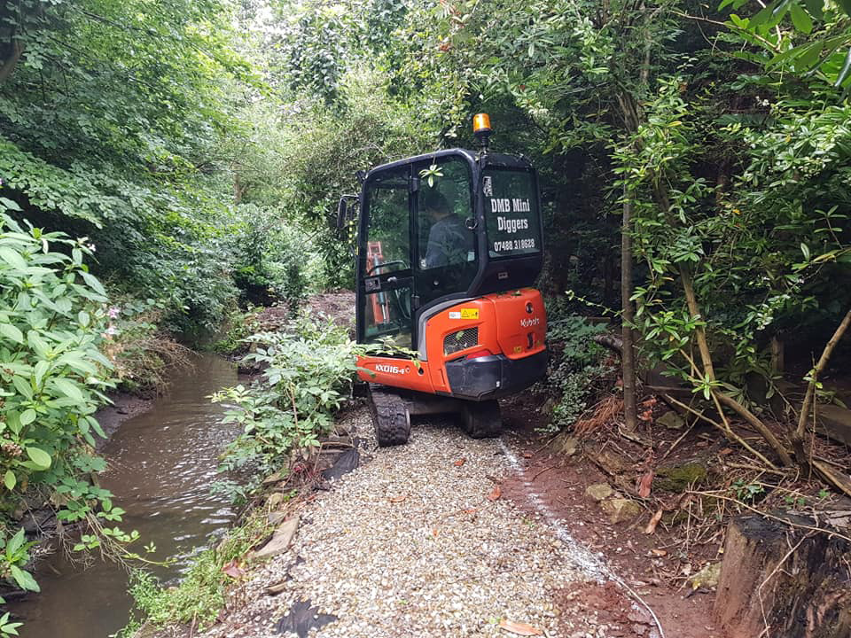 Mini digger at riverside