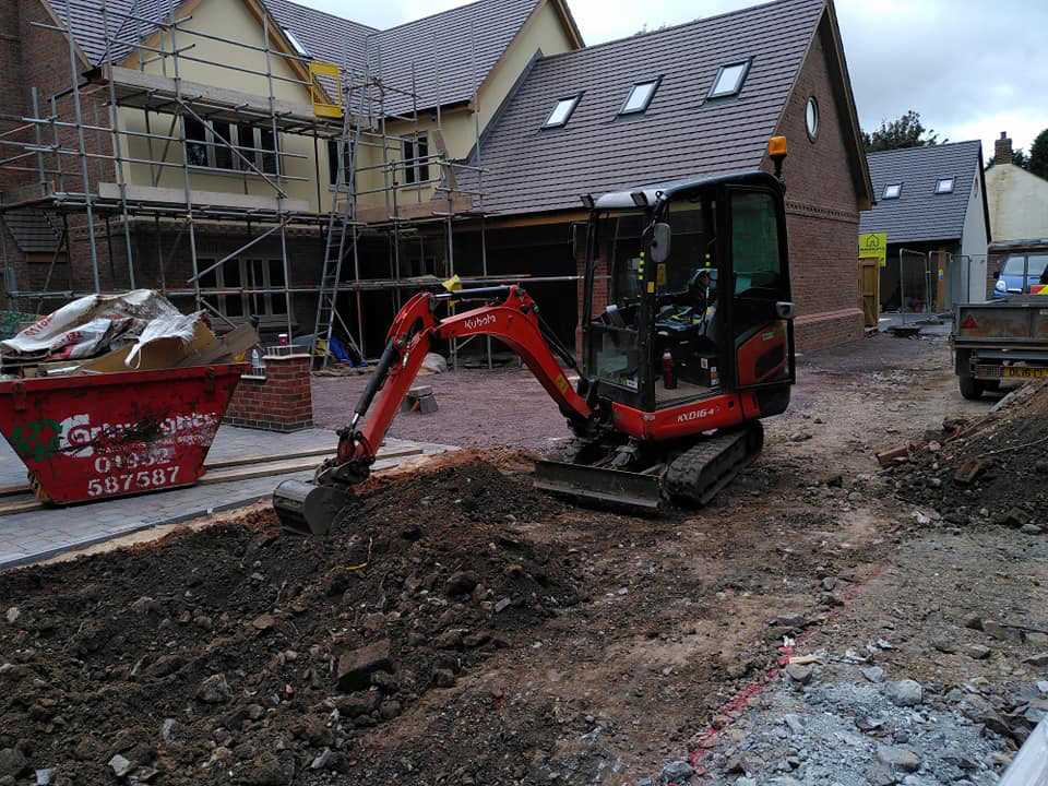 Mini digger landscaping new build house garden